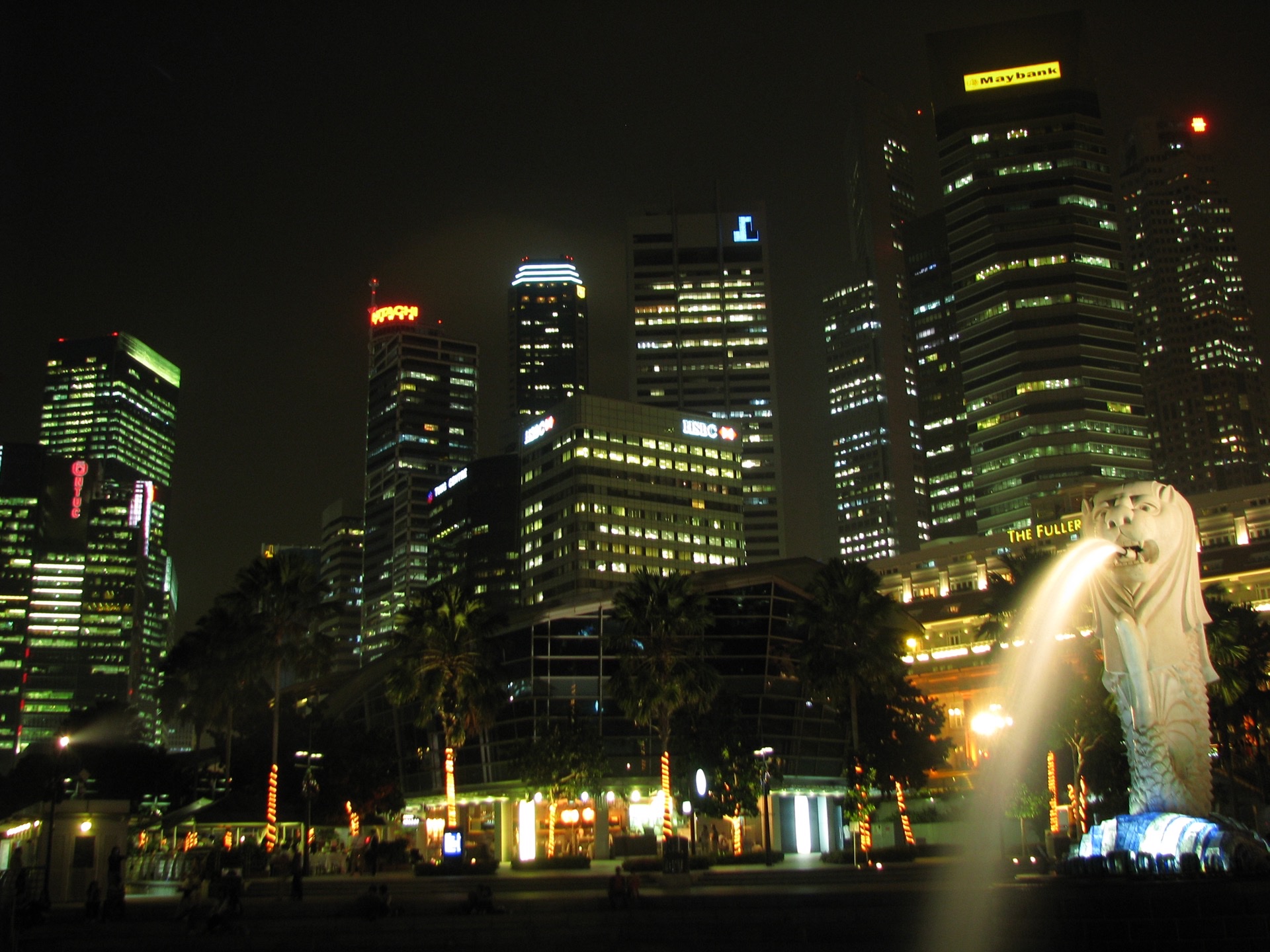 Singapore Raffles Place financial district at night with illuminated HSBC and international commercial bank towers
